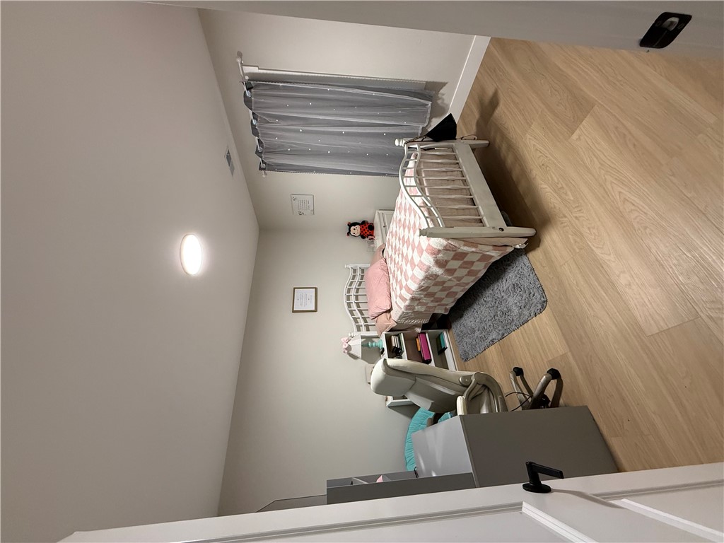 119 Dobbins Road Townville, SC 29689 - Photo 10 of 25 This cozy bedroom features light wood flooring and a modern ceiling light, creating a comfortable living space.