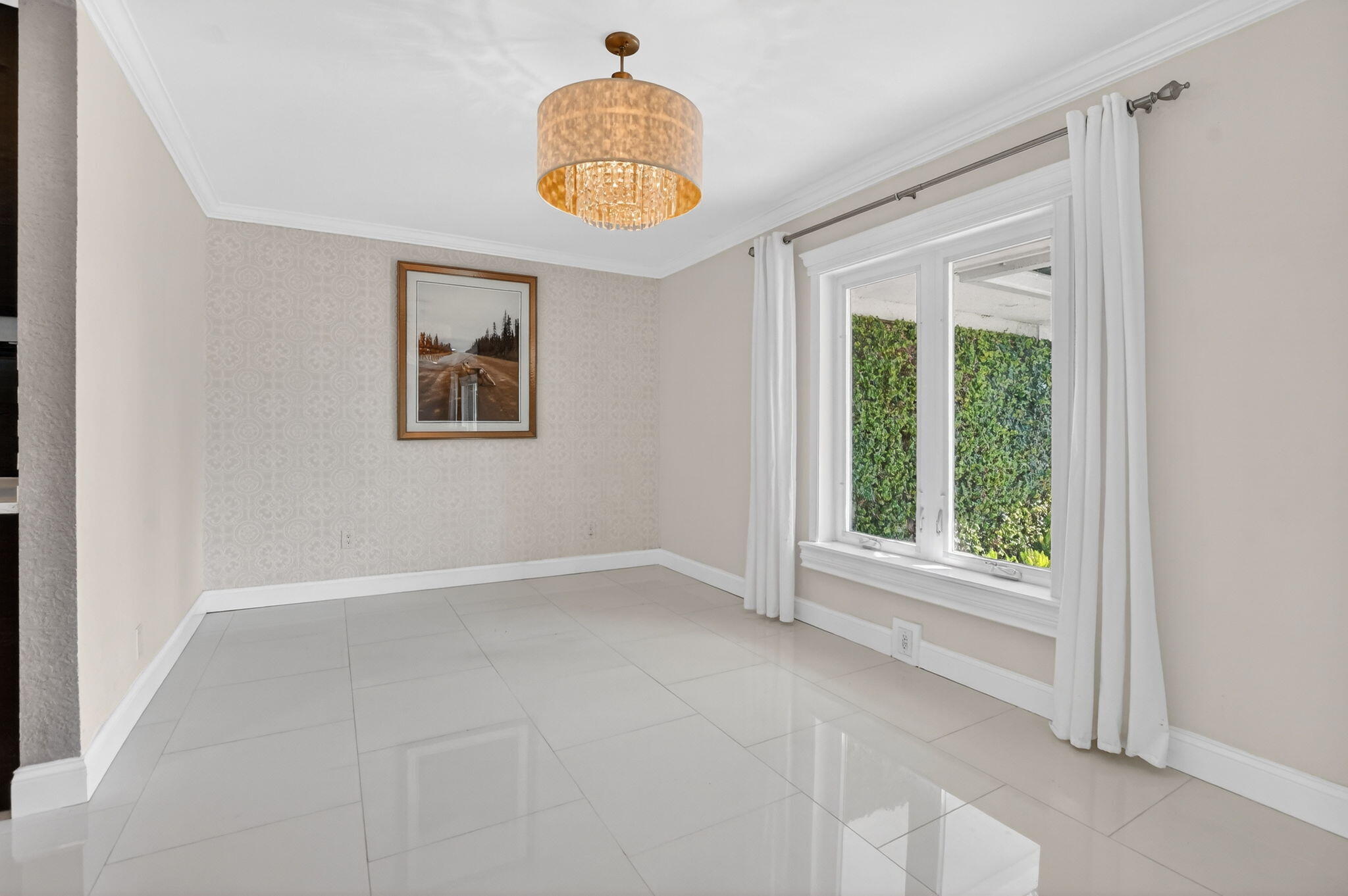1455 Isabel Road East Boca Raton, FL 33486 - Photo 11 of 33 an empty room with windows and chandelier