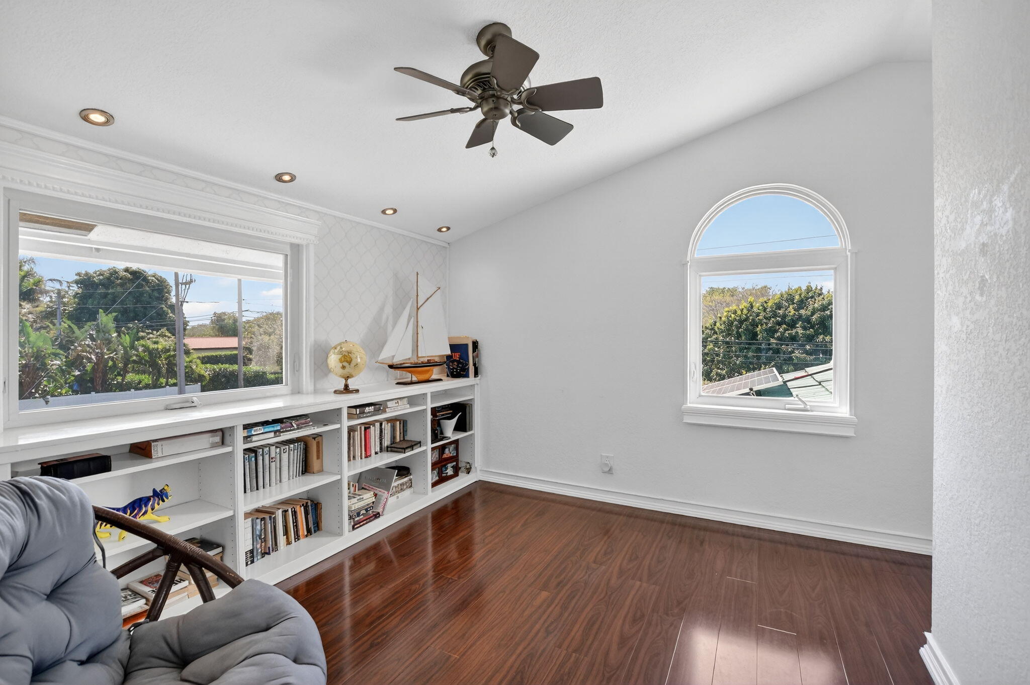 1455 Isabel Road East Boca Raton, FL 33486 - Photo 20 of 33 a view of a livingroom with furniture window wooden floor and a ceiling fan