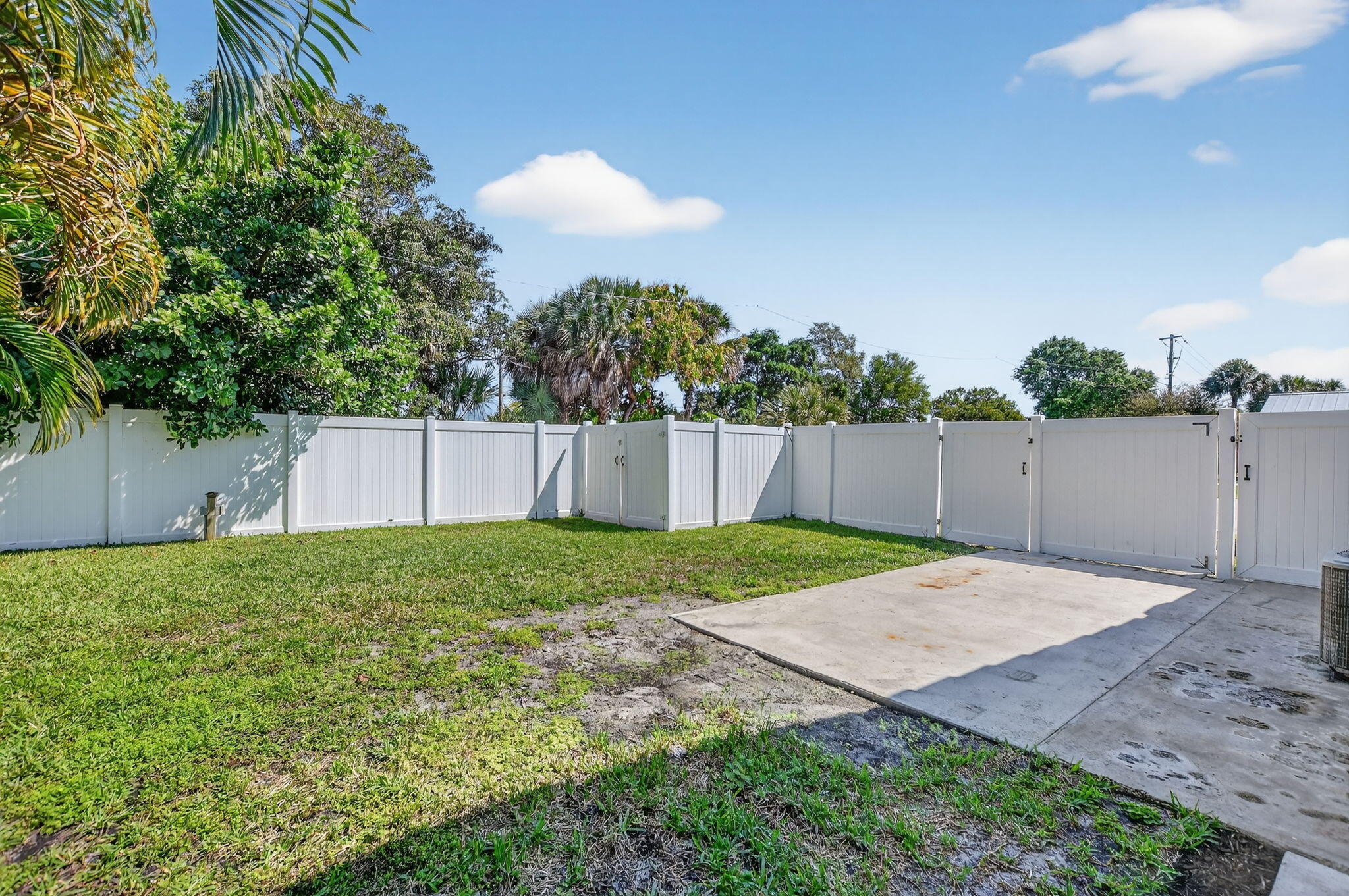 1455 Isabel Road East Boca Raton, FL 33486 - Photo 26 of 33 a view of a backyard with grass & fence