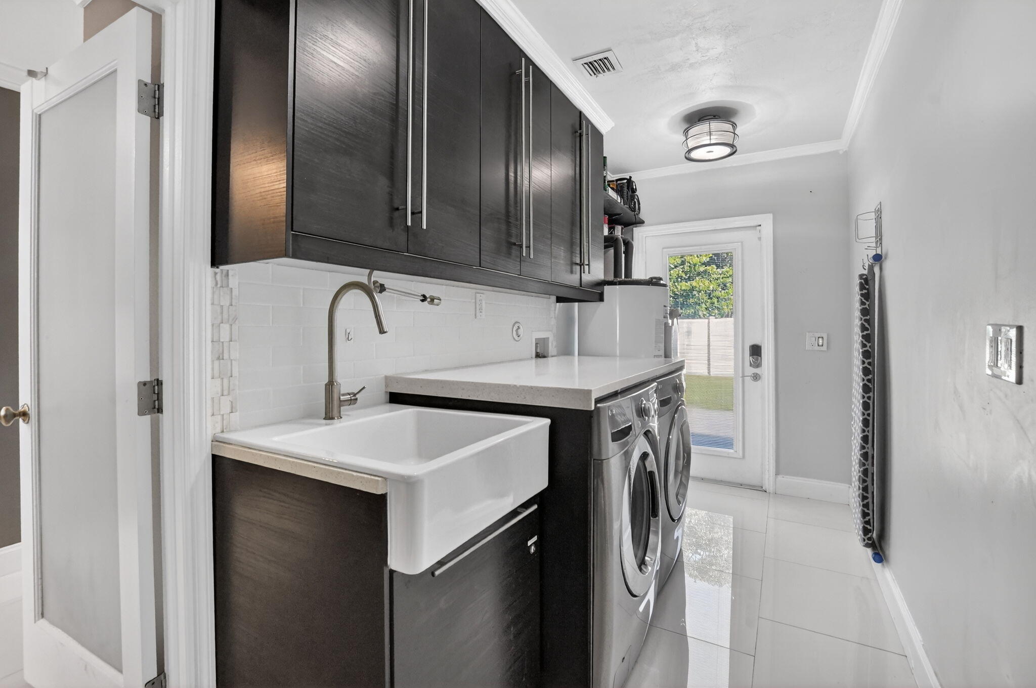 1455 Isabel Road East Boca Raton, FL 33486 - Photo 29 of 33 a utility room with cabinets washer and dryer