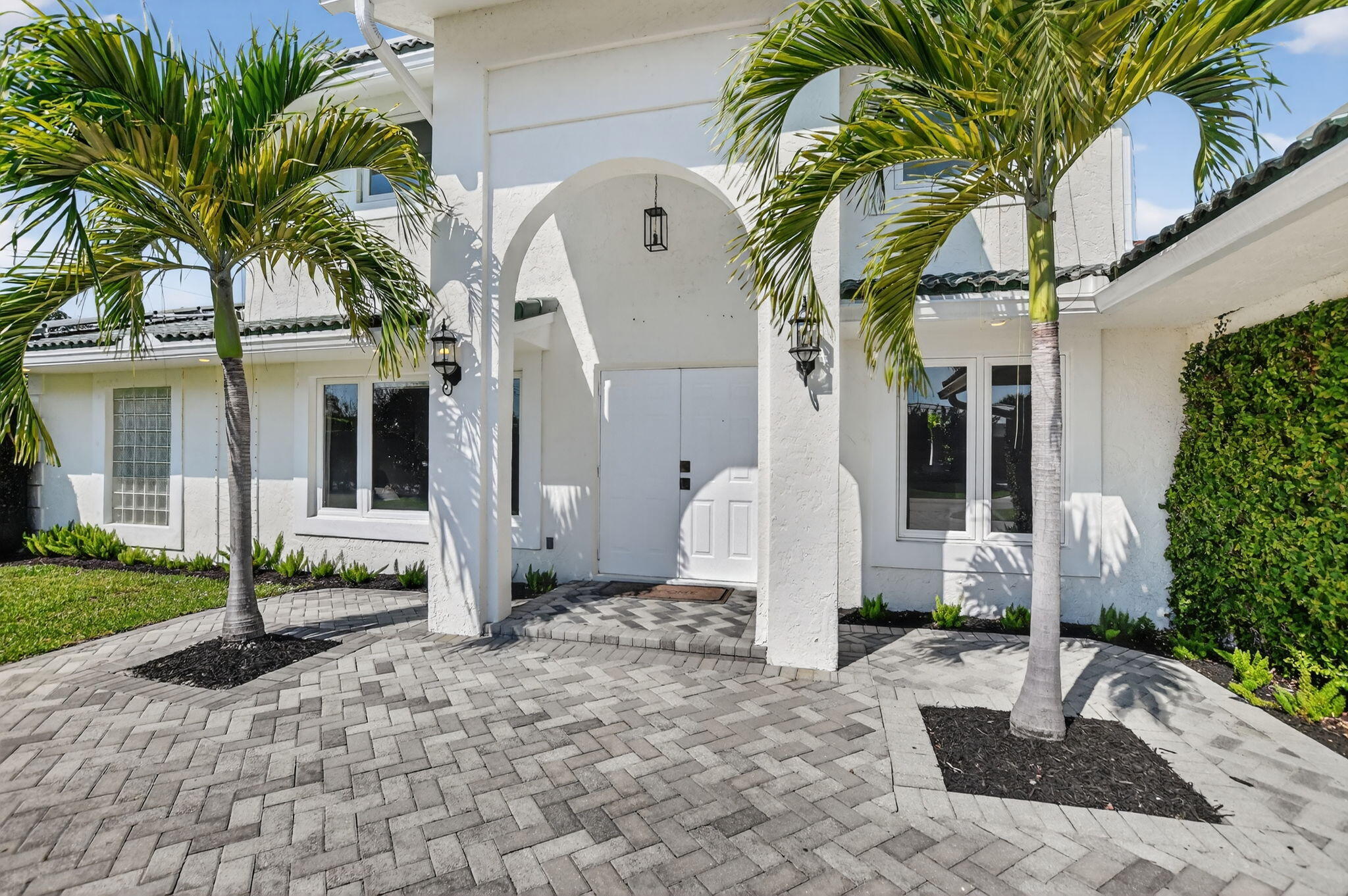 1455 Isabel Road East Boca Raton, FL 33486 - Photo 3 of 33 a front view of a house with garden