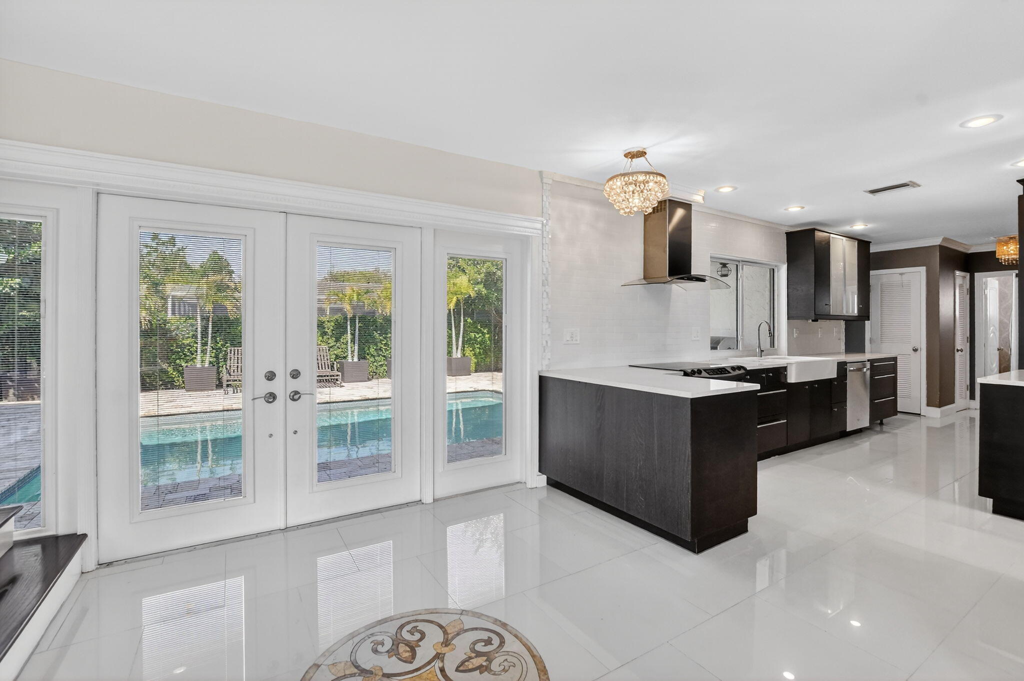 1455 Isabel Road East Boca Raton, FL 33486 - Photo 7 of 33 a large kitchen with a large counter top and stainless steel appliances