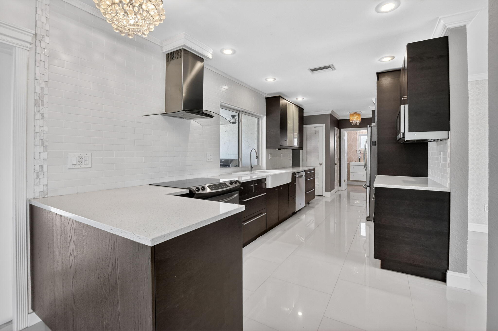 1455 Isabel Road East Boca Raton, FL 33486 - Photo 8 of 33 a kitchen with stainless steel appliances a stove top oven a sink and a refrigerator