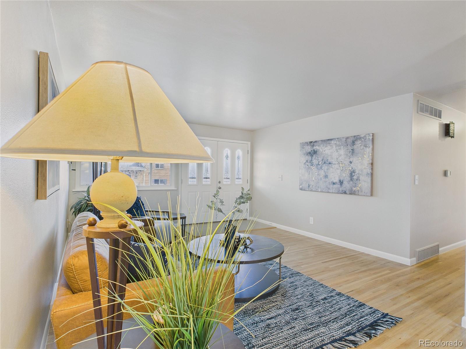 6085 Simms Street Arvada, CO 80004 - Photo 19 of 32 a view of a dining room with furniture and wooden floor