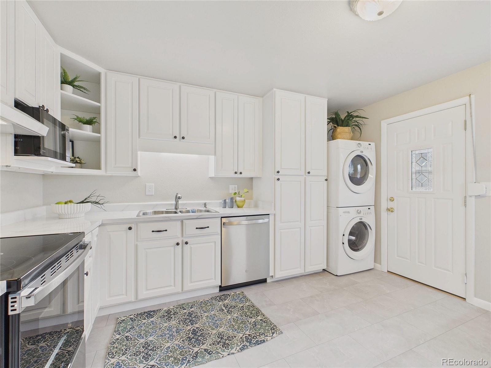 6085 Simms Street Arvada, CO 80004 - Photo 22 of 32 a spacious bathroom with a granite countertop sink and a mirror