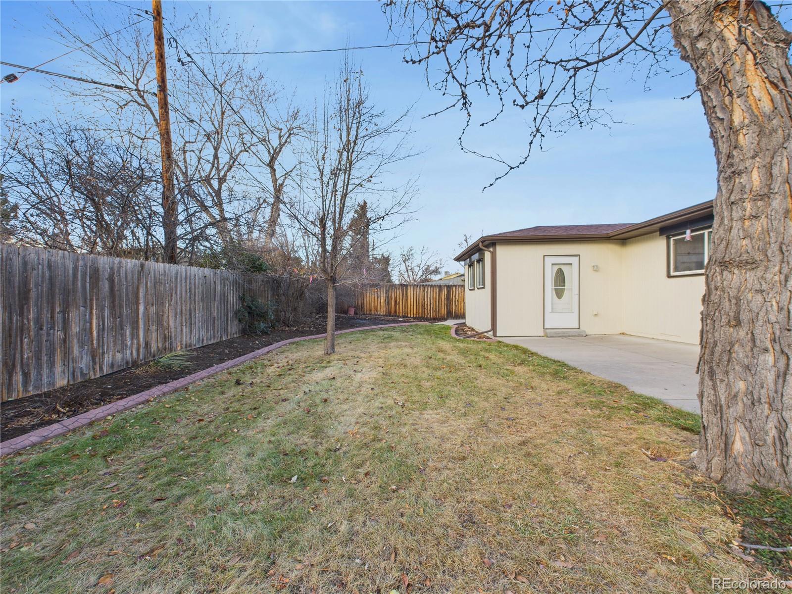 6085 Simms Street Arvada, CO 80004 - Photo 25 of 32 a view of garage and wooden fence