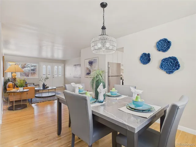 a view of a dining room with furniture wooden floor and chandelier