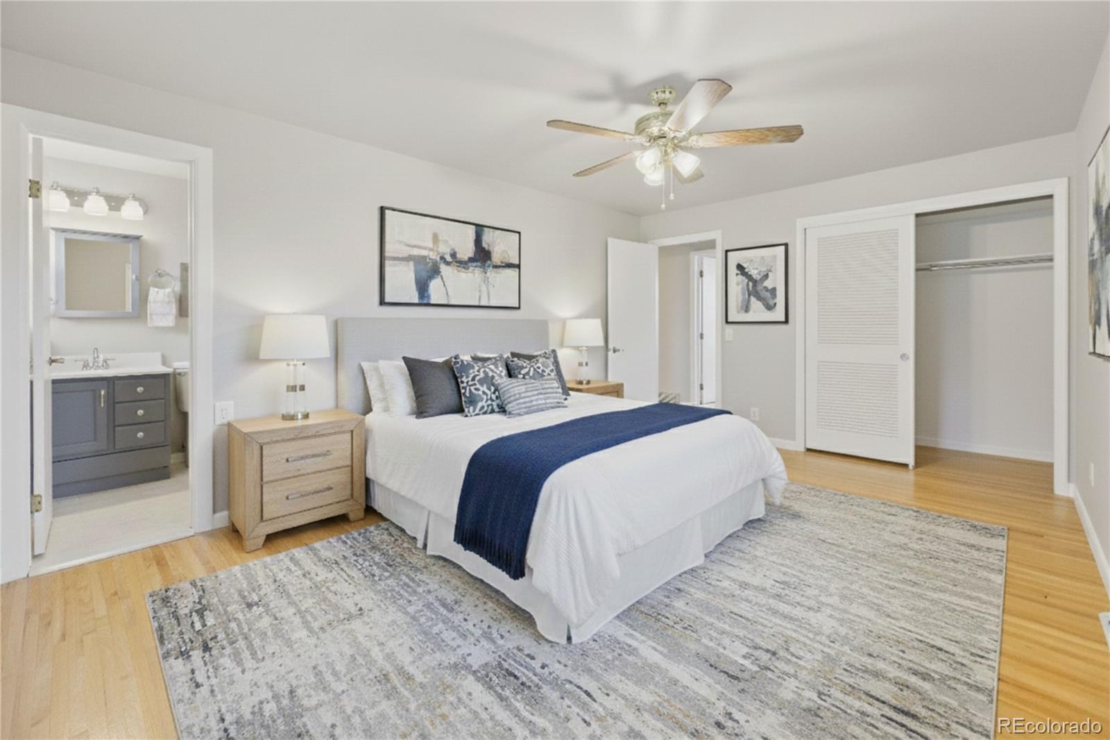 6085 Simms Street Arvada, CO 80004 - Photo 9 of 32 a bedroom with a large bed and a chandelier