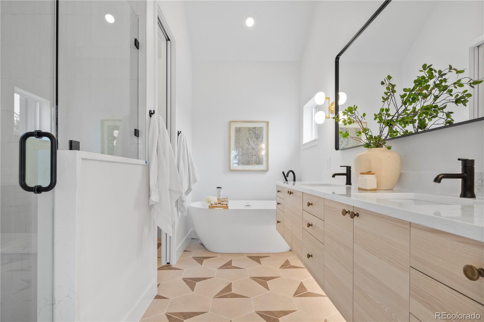 3283 Ames Street Wheat Ridge, CO 80212 - Photo 25 of 41 a spacious bathroom with a double vanity sink mirror and bathtub