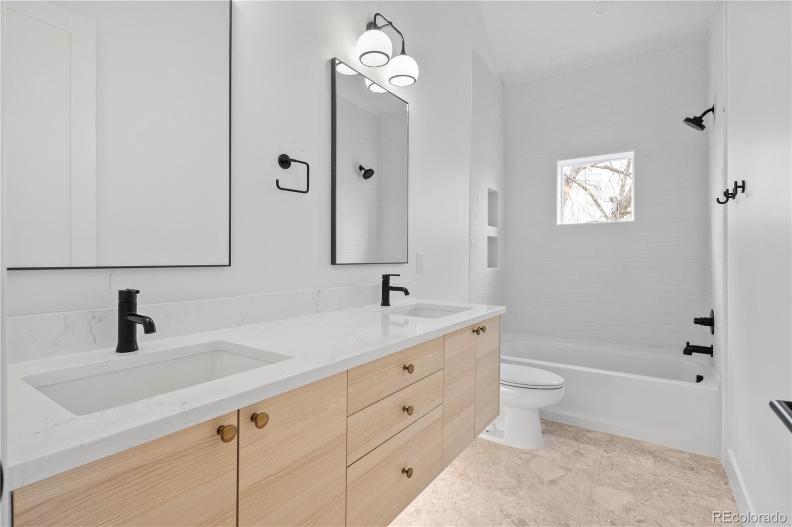 3283 Ames Street Wheat Ridge, CO 80212 - Photo 31 of 41 a bathroom with a sink a toilet and a mirror