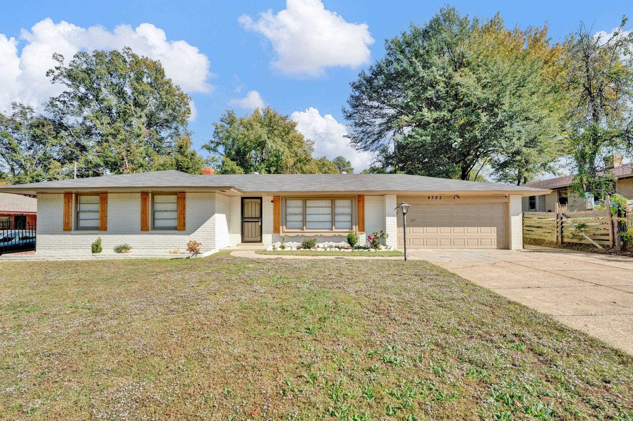 4382 Ruth Drive Memphis, TN 38109 - Photo 1 of 32 Ranch-style house featuring a garage and a front lawn