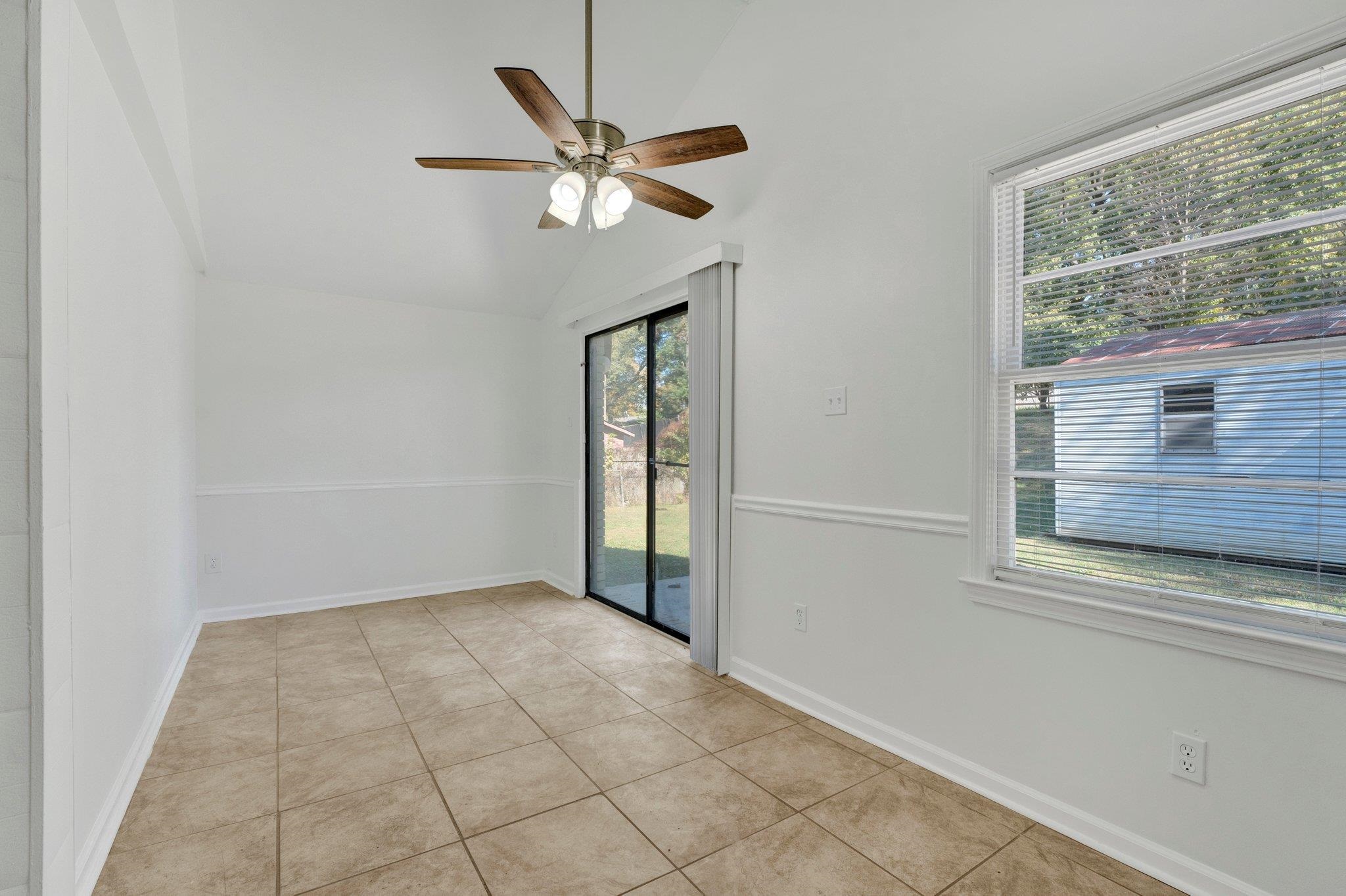 4382 Ruth Drive Memphis, TN 38109 - Photo 15 of 32 Unfurnished room with ceiling fan, light tile patterned flooring, and vaulted ceiling