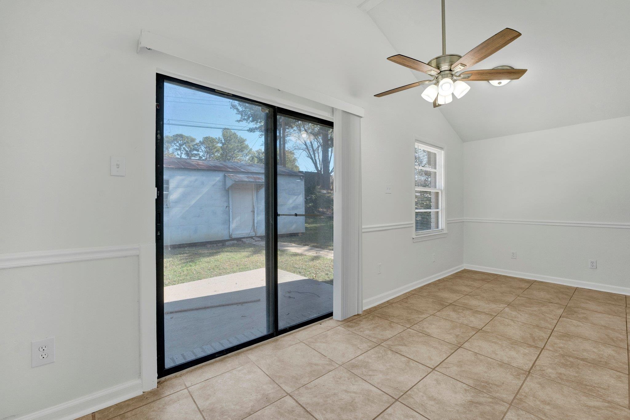 4382 Ruth Drive Memphis, TN 38109 - Photo 16 of 32 Interior space featuring ceiling fan, lofted ceiling, and plenty of natural light