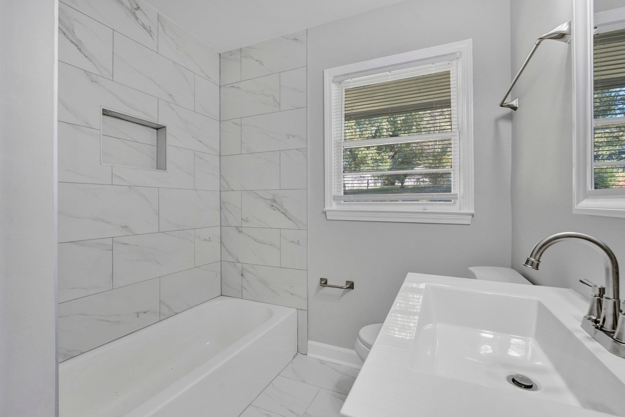 4382 Ruth Drive Memphis, TN 38109 - Photo 20 of 32 Full bathroom with toilet, tiled shower / bath combo, and vanity