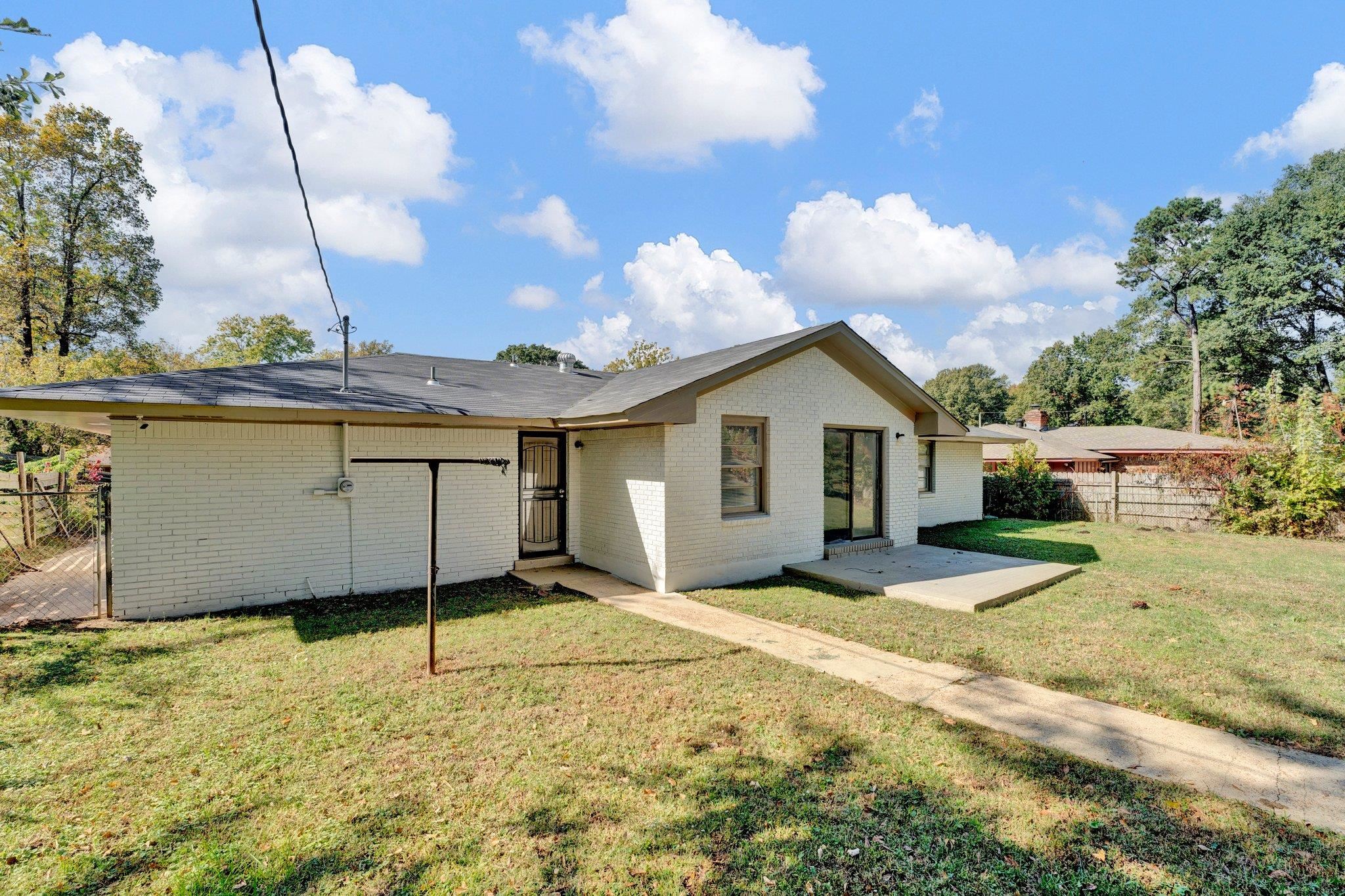4382 Ruth Drive Memphis, TN 38109 - Photo 29 of 32 Back of house featuring a patio area and a lawn