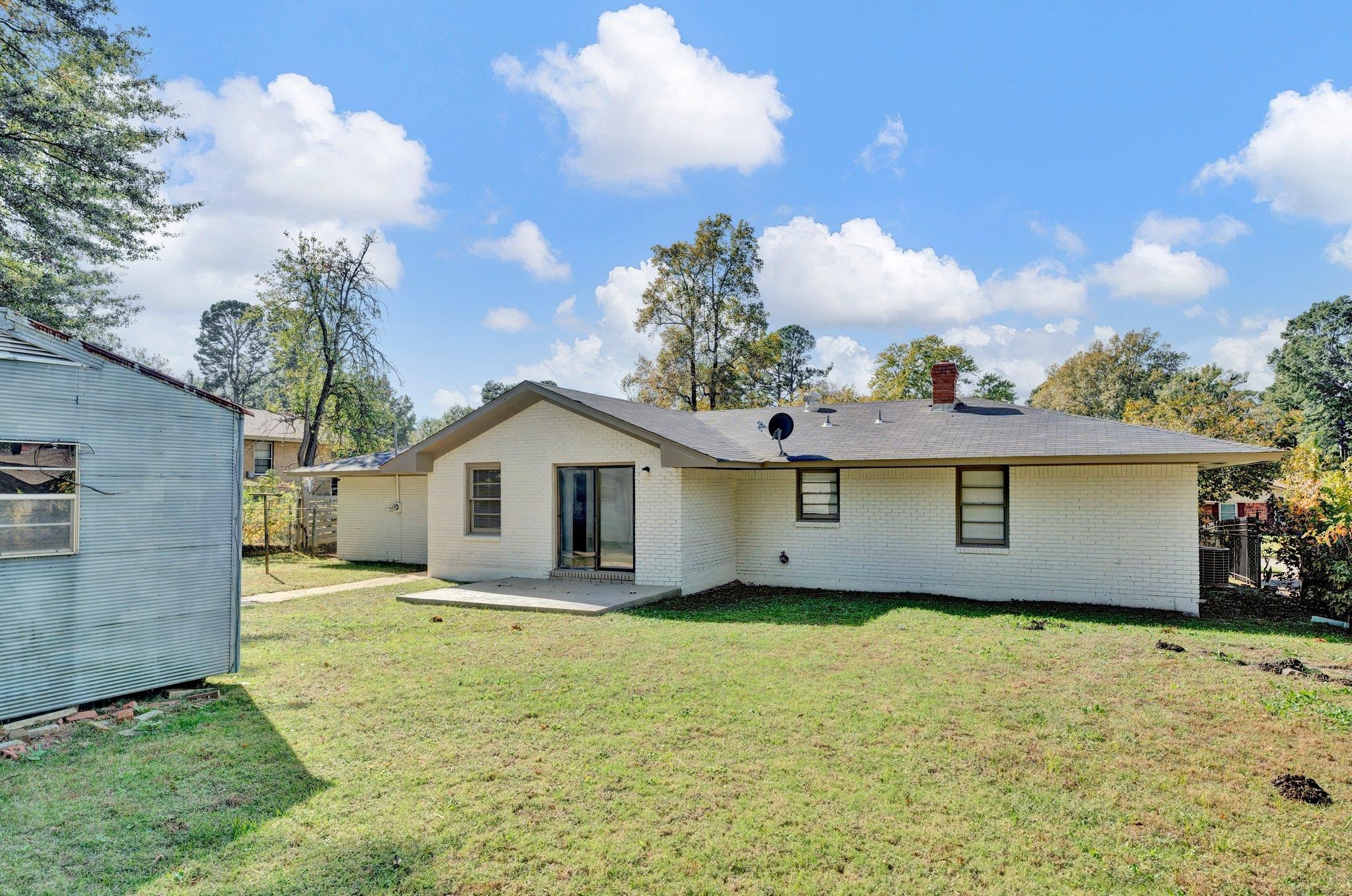 4382 Ruth Drive Memphis, TN 38109 - Photo 31 of 32 Rear view of property with a yard and a patio area