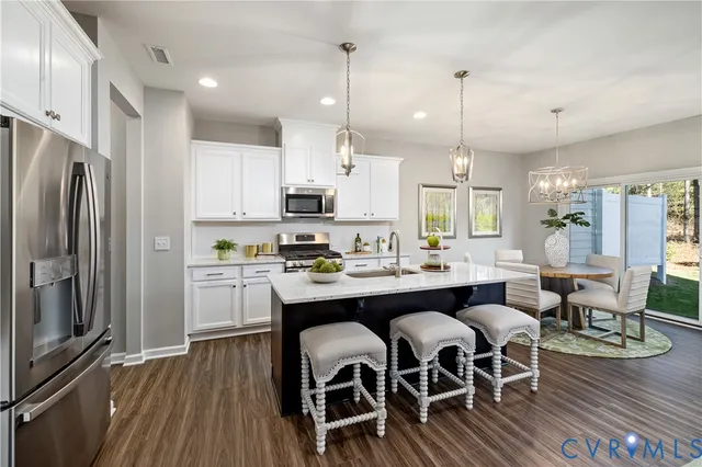 a large kitchen with a table and chairs