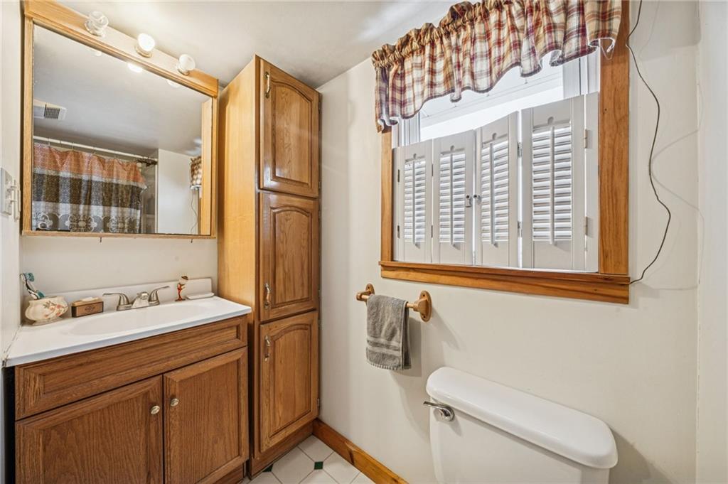 144 Double Hill Road Mount Pleasant, PA 15666 - Photo 23 of 41 a bathroom with a sink a toilet and a mirror
