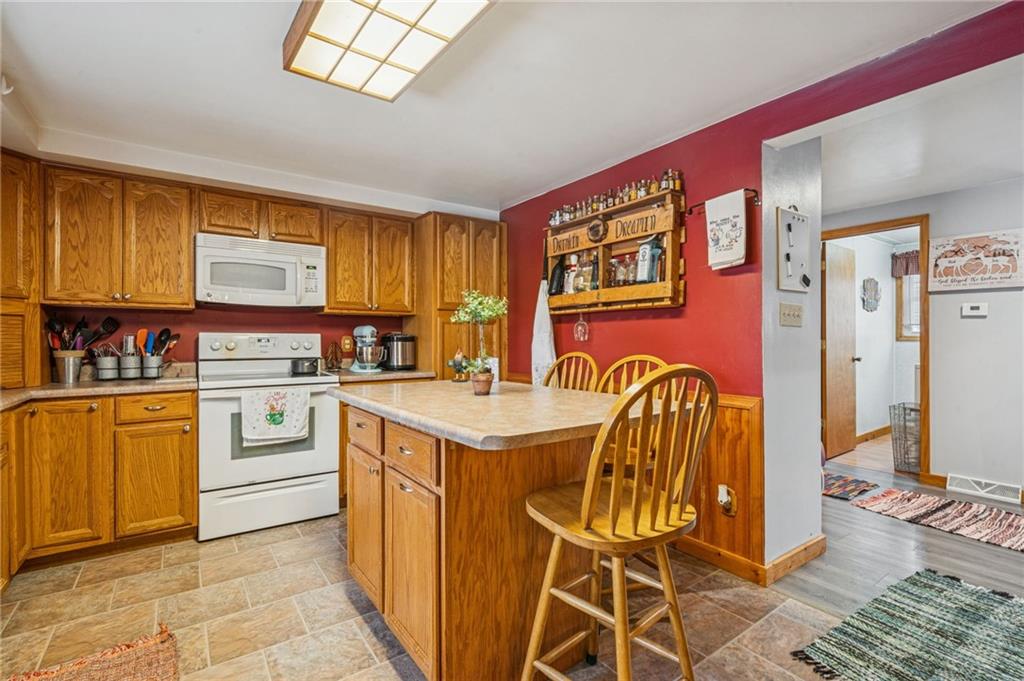 144 Double Hill Road Mount Pleasant, PA 15666 - Photo 7 of 41 a kitchen with stainless steel appliances granite countertop a stove a sink and a refrigerator