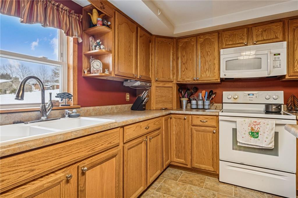 144 Double Hill Road Mount Pleasant, PA 15666 - Photo 8 of 41 a kitchen with stainless steel appliances granite countertop a sink and cabinets