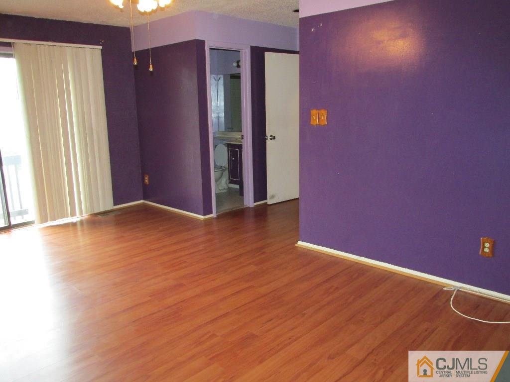 136 Westgate Drive Edison, NJ 08820 - Photo 11 of 19 a view of an empty room with wooden floor and a window