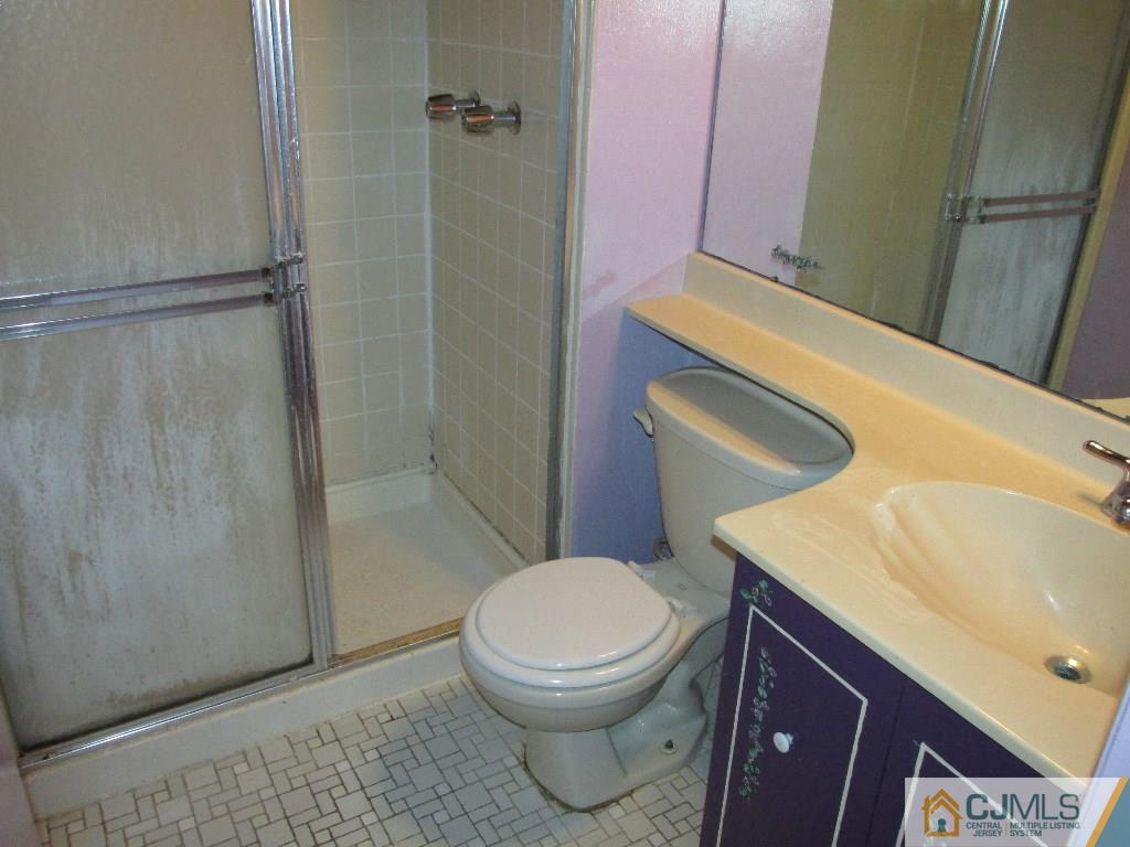 136 Westgate Drive Edison, NJ 08820 - Photo 12 of 19 a bathroom with a sink a toilet and shower