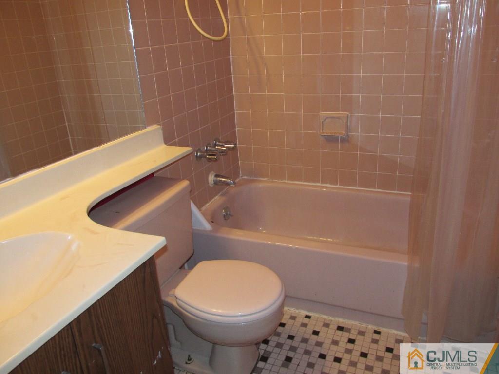 136 Westgate Drive Edison, NJ 08820 - Photo 13 of 19 a bathroom with a sink a toilet and shower
