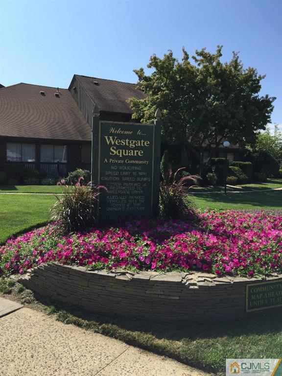 136 Westgate Drive Edison, NJ 08820 - Photo 16 of 19 a street sign in front of flowers