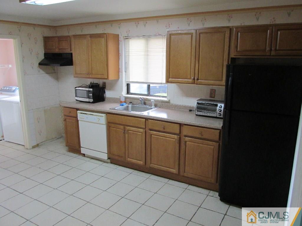 136 Westgate Drive Edison, NJ 08820 - Photo 4 of 19 a kitchen with stainless steel appliances a sink stove and cabinets