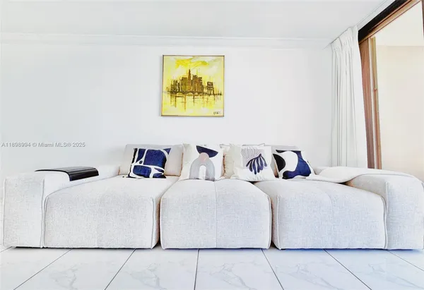 a bedroom with a bed and painting on the wall