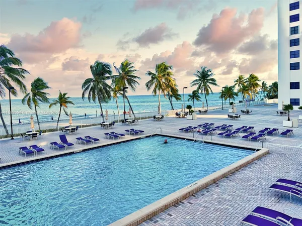 a view of a swimming pool and lounge chair