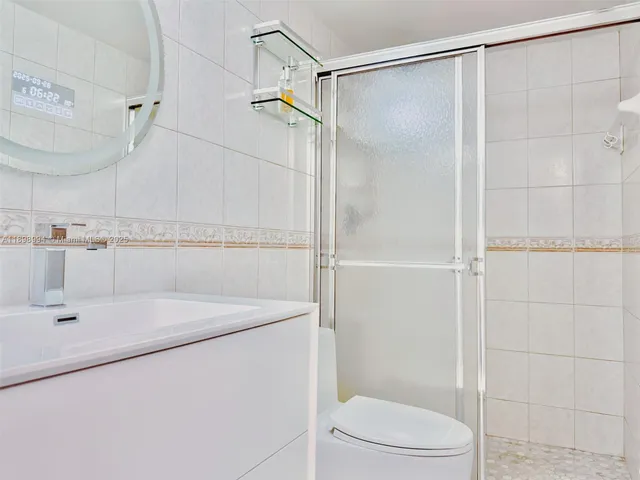 a bathroom with a shower and a sink