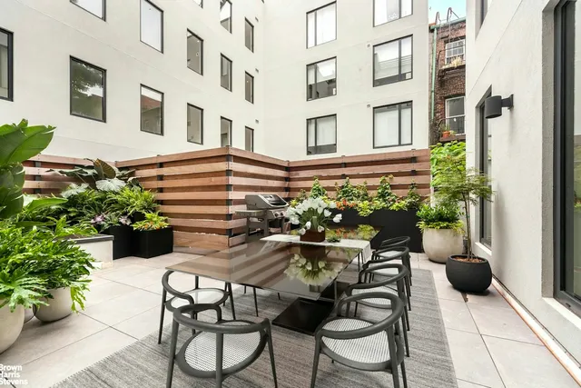a view of a patio with table and chairs and potted plants