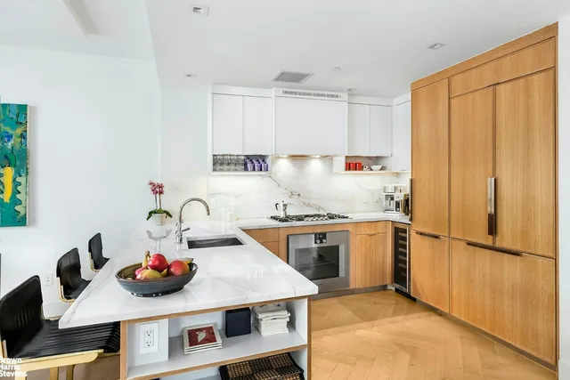 a kitchen with a stove a sink and a refrigerator