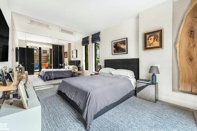 a bedroom with bed and glass door