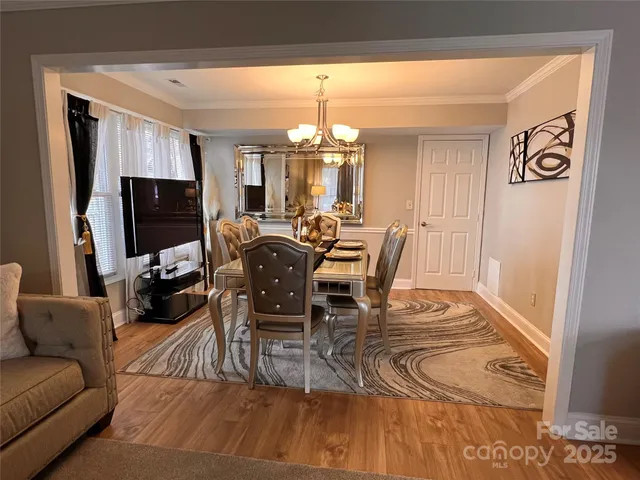a view of a dining room with furniture and chandelier