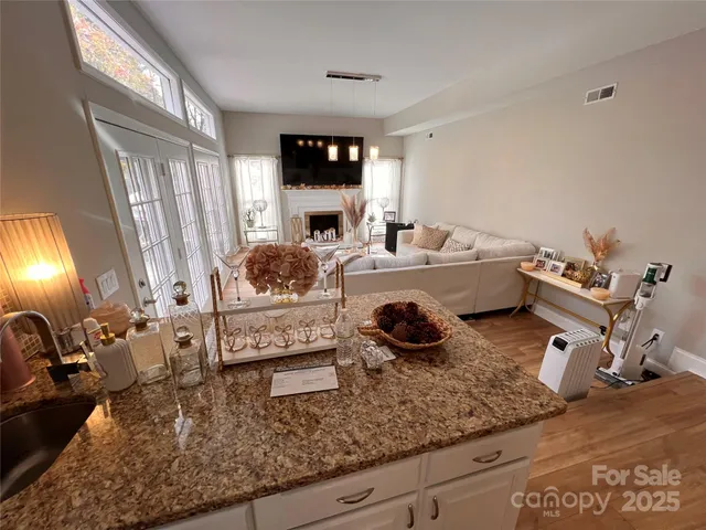 a kitchen with sink and view of living room