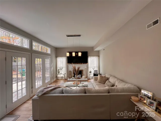 a living room with furniture and a wooden floor
