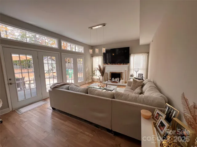 a living room with fireplace furniture and a wooden floor