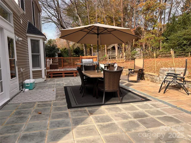 a view of a chairs and table in the back yard of the house