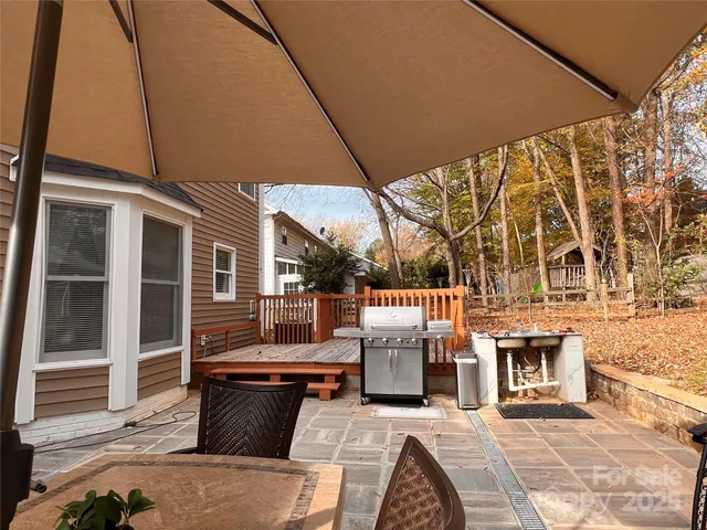 a view of a patio with couches table and chairs and potted plants