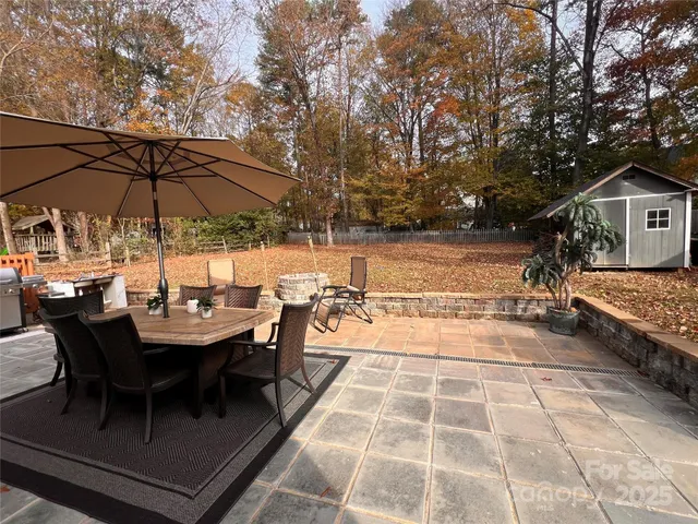a view of a patio with chairs and table