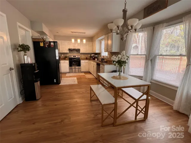 a living room with kitchen island granite countertop furniture a fireplace and a large window