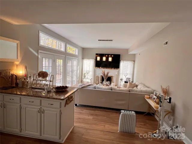 a living room with furniture tv and a large window