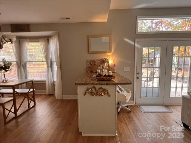 a living room with furniture and a mirror
