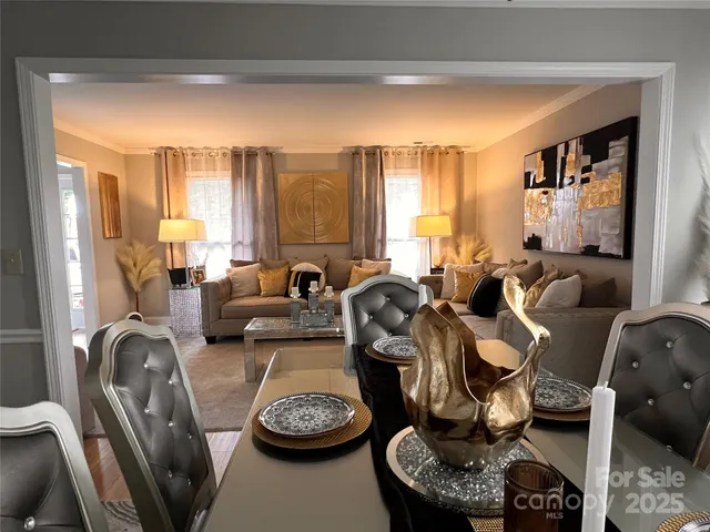 a view of a a dining room with furniture window and wooden floor