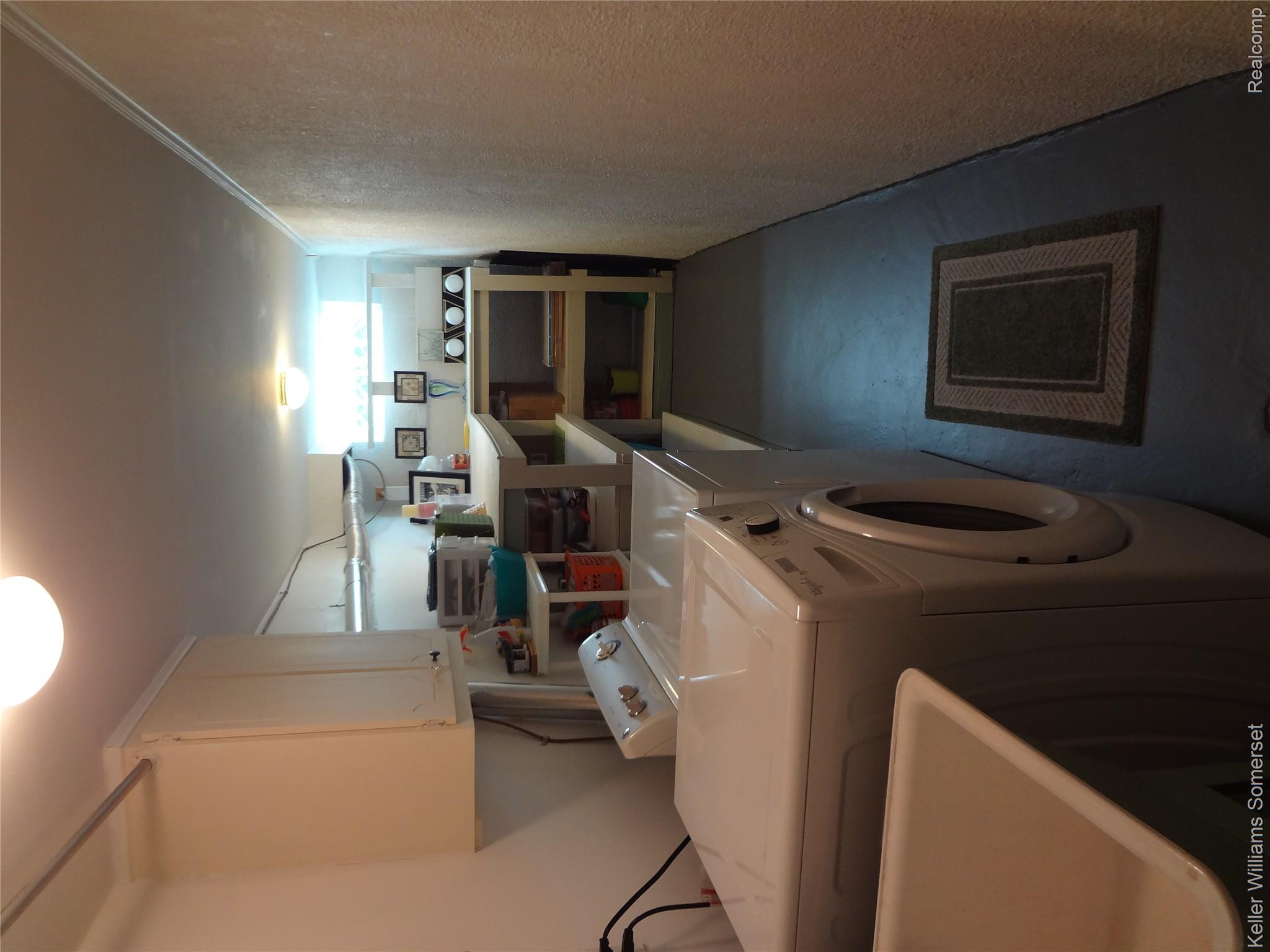 29626 Hoover Road, Unit 626 Warren, MI 48093 - Photo 28 of 35 Laundry room with a textured wall, washer and dryer, and cabinet space