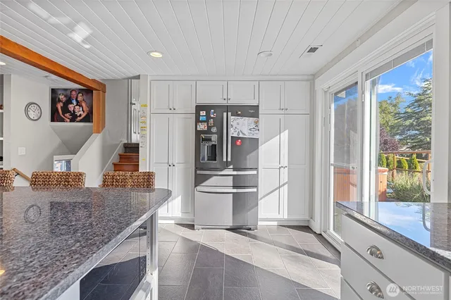 a kitchen with a refrigerator and a sink