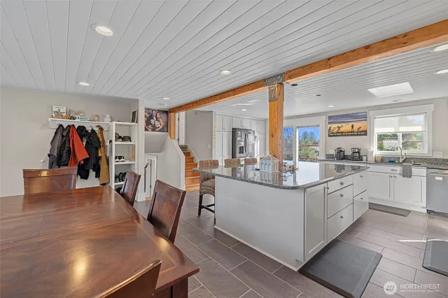 a large white kitchen with a large window
